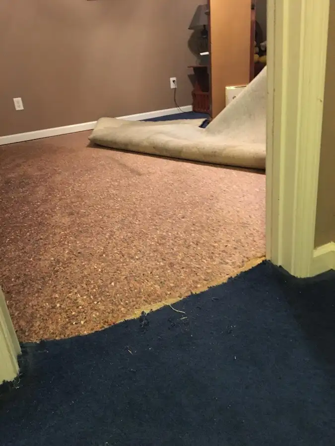 Carpet pad removal revealing water damage during Water Mitigation Services in Waikele